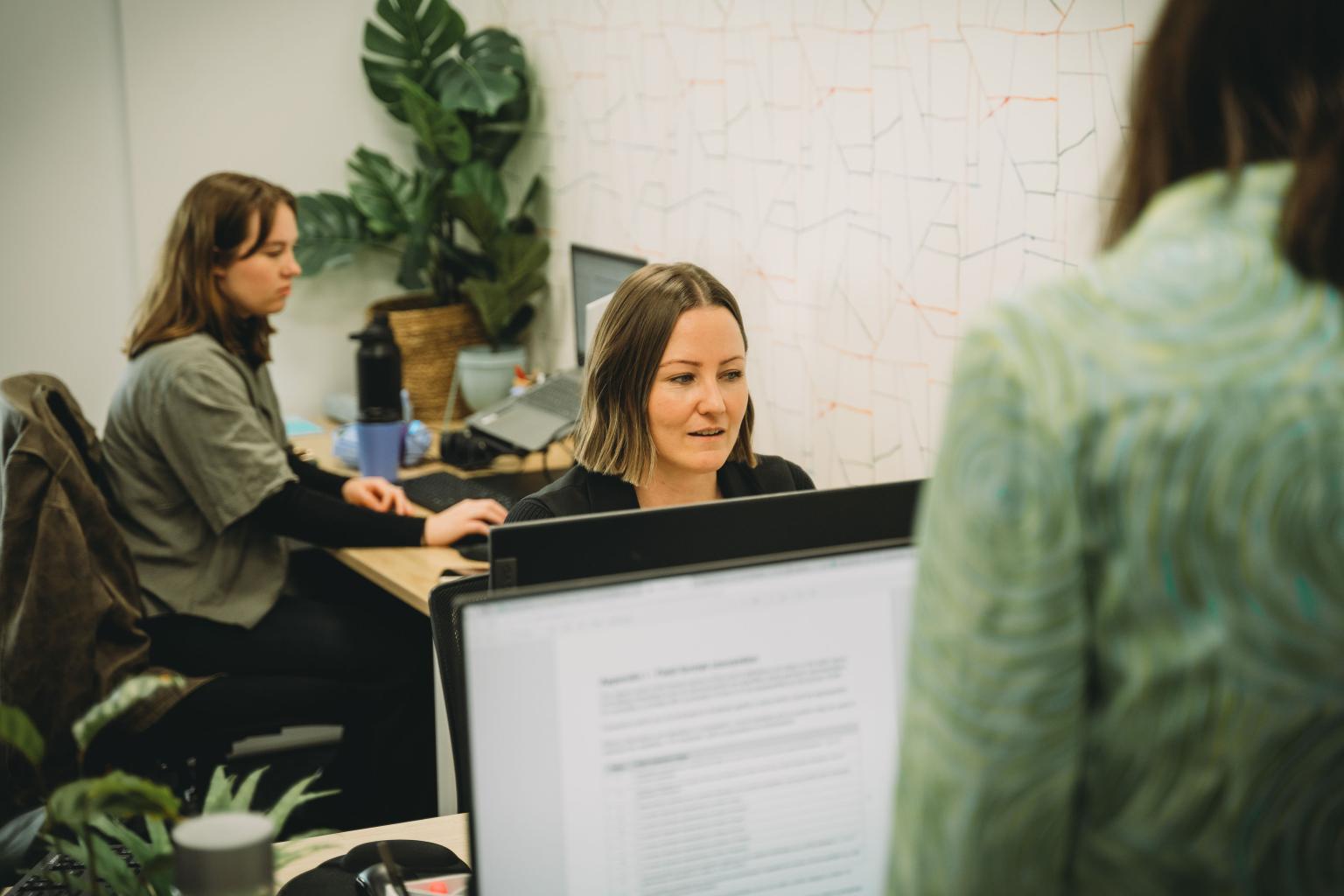 Resource Hub team member developing waste facility documentation in Brisbane office